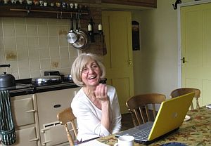 Barbara Read at laptop in farm house kitchen
